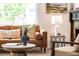 Bright living room showcasing a comfortable seating area, stylish decor, and a glimpse of the elegant fireplace at 230 E Ellsworth Ave, Denver, CO 80209