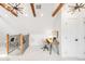Lofted office space with wooden beams, neutral decor, and stylish light fixture at 230 E Ellsworth Ave, Denver, CO 80209