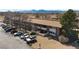 Aerial view of apartment complex with a parking lot, mountains, and a visitor lot at 5102 Williams Fork Trl # 201, Boulder, CO 80301