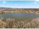 Breathtaking aerial view of a lake surrounded by trees, with community housing in the background at 5102 Williams Fork Trl # 201, Boulder, CO 80301