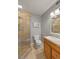 Bathroom with a shower, gray walls, cabinet storage, and a large mirror at 5102 Williams Fork Trl # 201, Boulder, CO 80301
