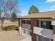 Upper exterior view of a brick apartment complex with a brown roof and green trim at 5102 Williams Fork Trl # 201, Boulder, CO 80301