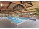 Indoor pool with natural light, wood paneling, and lounge chairs at 5102 Williams Fork Trl # 201, Boulder, CO 80301