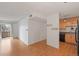 A spacious living area with hardwood floors leading to a balcony and connecting to an adjacent kitchen space at 5102 Williams Fork Trl # 201, Boulder, CO 80301