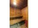 A wooden sauna room with benches and a sauna heater at 5102 Williams Fork Trl # 201, Boulder, CO 80301