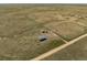 An aerial view of a ranch with a house, barn and country road at 13640 County Road 182, Bennett, CO 80102
