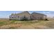 Exterior view of home with fenced backyard, offering a private outdoor space for relaxation and entertainment at 13640 County Road 182, Bennett, CO 80102