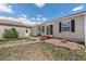 The backyard has a small stone patio with stairs, plus access to the home, garage, and yard at 13640 County Road 182, Bennett, CO 80102