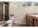 Well-lit bathroom featuring a walk-in shower, tile floors, and neutral wall colors, enhancing the property's appeal at 13640 County Road 182, Bennett, CO 80102