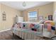 Bright bedroom featuring wood floors and large window overlooking pasture at 13640 County Road 182, Bennett, CO 80102