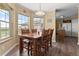 Bright dining room with a wooden table set, large windows offering scenic views, and an open layout at 13640 County Road 182, Bennett, CO 80102