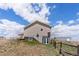 Exterior rear view of home featuring a walkout basement, enhancing the property's appeal at 13640 County Road 182, Bennett, CO 80102