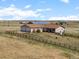 Ranch style home with attached garage and backyard with wooden fence sitting on a grassy lot at 13640 County Road 182, Bennett, CO 80102