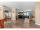 Open-concept living room boasts hardwood floors, a fireplace, and large windows for lots of natural light at 13640 County Road 182, Bennett, CO 80102