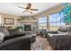 Cozy living room featuring a fireplace, comfortable seating, large windows, and views of the surrounding landscape at 13640 County Road 182, Bennett, CO 80102