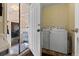 Convenient mudroom featuring a washer and dryer, offering practicality and ease of use for daily chores at 13640 County Road 182, Bennett, CO 80102