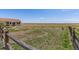 Expansive fenced backyard, perfect for outdoor activities, with home visible in the background at 13640 County Road 182, Bennett, CO 80102