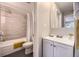 Bathroom with shower over tub, featuring modern tiling and fixtures at 937 N Clarkson St # 405, Denver, CO 80218