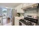 Updated kitchen with stainless steel refrigerator and range with modern tile backsplash at 937 N Clarkson St # 405, Denver, CO 80218