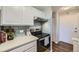 White kitchen cabinets and modern stainless steel appliances give a bright, updated feel at 937 N Clarkson St # 405, Denver, CO 80218