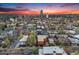 This aerial view captures a beautiful sunset over a dense neighborhood at 20 S Logan St # 104, Denver, CO 80209