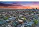 Expansive aerial view of the city with a vibrant sunset and distant mountain range at 20 S Logan St # 104, Denver, CO 80209
