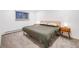 Clean, modern bedroom with a queen-sized bed, two side tables with lamps, and large window at 20 S Logan St # 104, Denver, CO 80209