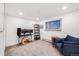 Inviting bedroom with neutral carpeting, a comfortable couch and large window providing natural light at 20 S Logan St # 104, Denver, CO 80209