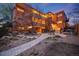 Exterior dusk shot featuring well maintained landscaping, courtyard, fountain and walkways at complex at 20 S Logan St # 104, Denver, CO 80209