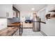 Bright kitchen and dining area with white cabinets, stainless steel appliances, and stylish blue decor at 20 S Logan St # 104, Denver, CO 80209