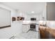 Bright kitchen featuring white cabinets, stainless steel appliances, tiled backsplash, and butcher block countertops at 20 S Logan St # 104, Denver, CO 80209