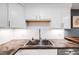Close up of kitchen area with updated sink, white subway tile backsplash, and dark countertops at 20 S Logan St # 104, Denver, CO 80209