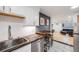 Open floorplan kitchen with counter seating and seamless transition to living area at 20 S Logan St # 104, Denver, CO 80209