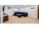 Inviting living room features hardwood floors, a window, and a comfortable blue sectional sofa with an ottoman at 20 S Logan St # 104, Denver, CO 80209