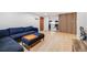 Cozy living room features hardwood floors, and a comfortable blue sectional sofa leading to the kitchen at 20 S Logan St # 104, Denver, CO 80209