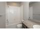 A clean bathroom featuring a shower/tub combination and a vanity with a granite countertop at 630 E Hinsdale Ave, Littleton, CO 80122