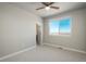 A bright bedroom with neutral tones, a ceiling fan and a window offering natural light at 630 E Hinsdale Ave, Littleton, CO 80122
