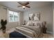 A neatly decorated bedroom featuring neutral tones, a ceiling fan, and serene artwork at 630 E Hinsdale Ave, Littleton, CO 80122