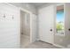 Bright entryway with a closet, featuring stylish shiplap walls, tile flooring, and access to a functional mudroom at 630 E Hinsdale Ave, Littleton, CO 80122
