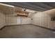Unfinished garage with painted walls and door to the backyard at 630 E Hinsdale Ave, Littleton, CO 80122