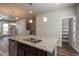 Kitchen island sink with granite countertops and wood floors, perfect for prep and entertaining in style at 630 E Hinsdale Ave, Littleton, CO 80122