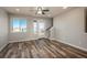 Bright and airy living room with wood floors, large windows, and seamless access to a private balcony at 630 E Hinsdale Ave, Littleton, CO 80122
