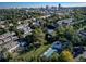An aerial view highlights a community pool, tennis court and mature trees in the neighborhood at 6810 E Appleton Ct, Centennial, CO 80112