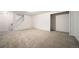 Finished basement featuring neutral carpeting, stairway and open room concept at 6810 E Appleton Ct, Centennial, CO 80112