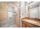 Well-lit bathroom featuring a glass-enclosed tiled shower and granite vanity top at 6810 E Appleton Ct, Centennial, CO 80112