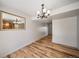 Bright dining room featuring hardwood floors, modern chandelier, and a decorative mirror at 6810 E Appleton Ct, Centennial, CO 80112