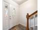 Bright foyer with a decorative front door, staircase, and tile flooring at 6810 E Appleton Ct, Centennial, CO 80112