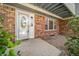 Inviting front entrance featuring a decorative glass door, brick facade, and manicured landscaping at 6810 E Appleton Ct, Centennial, CO 80112