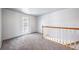 Upstairs landing area with gray carpet, a door to the outside and a staircase at 6810 E Appleton Ct, Centennial, CO 80112