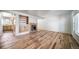 Open-concept living room boasting gleaming hardwood floors, built-in shelving, and a cozy fireplace at 6810 E Appleton Ct, Centennial, CO 80112